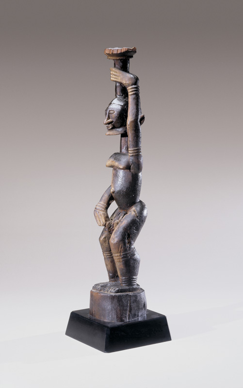 Standing Male Figure Holding Object Above Head